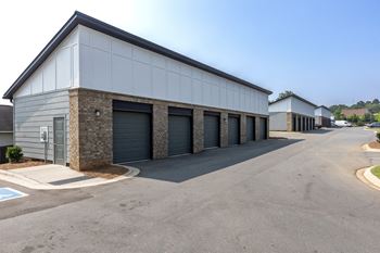 a row of garages with garages on each side of the building at Century University City, North Carolina